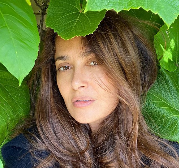 Salma Hayek poses amid leaves