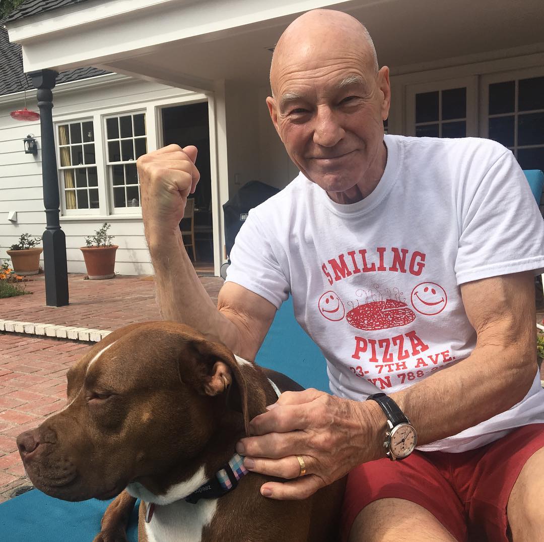 A photo f patrick Stewart by the pull with his Pitbull.