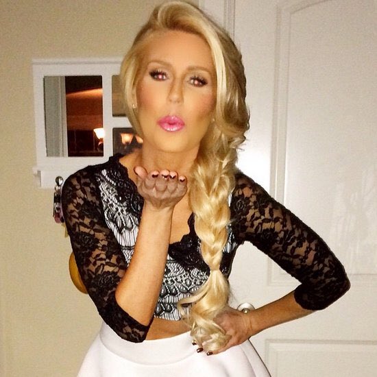 Gretchen Rossi wears a black lace outfit shirt and white skirt.