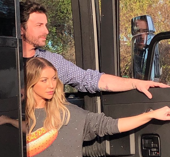 Beau Clark and Stassi Schroeder get off a bus.