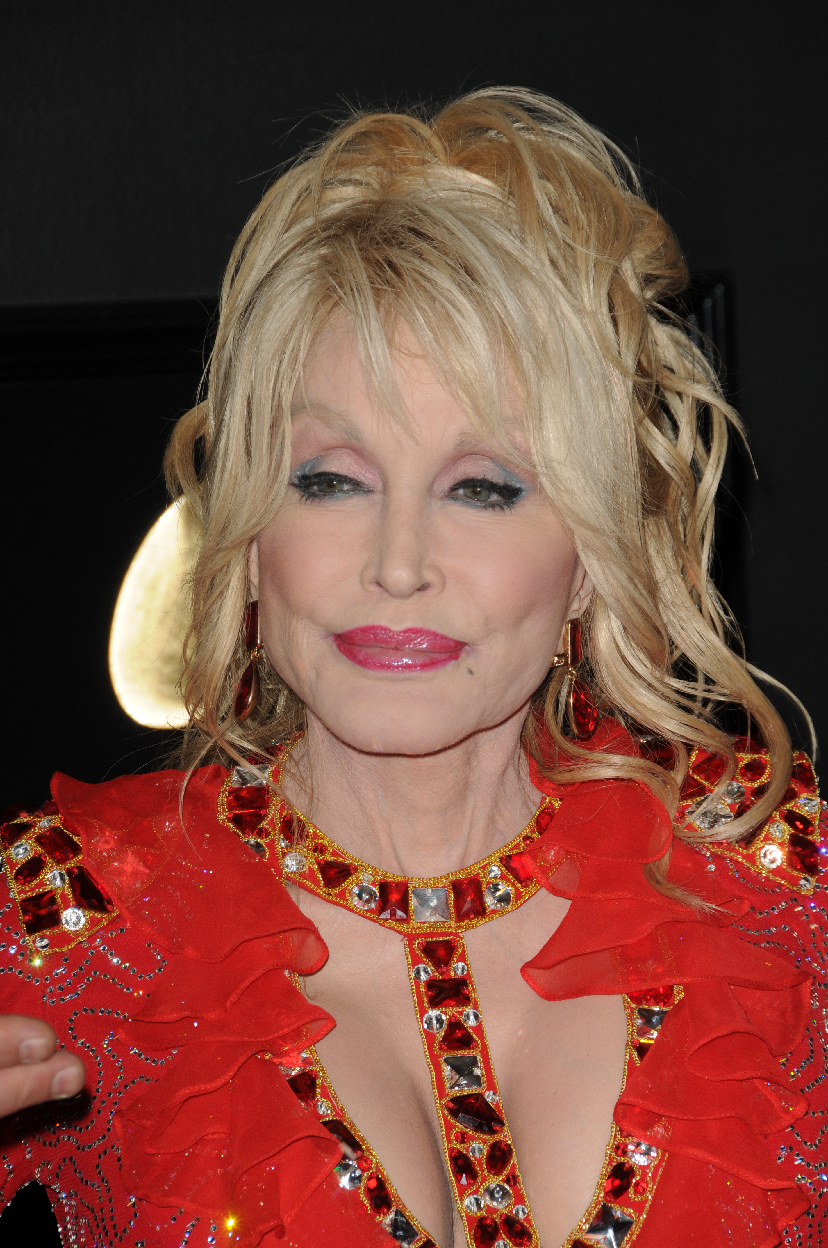 Dolly Parton in a red outfit. 