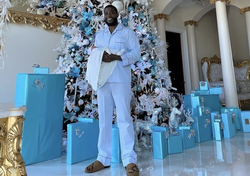 Gucci with his son under a massive Christmas tree.