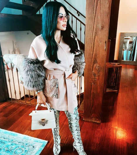 Jen Shah wears a fur coat and snakeskin boots.