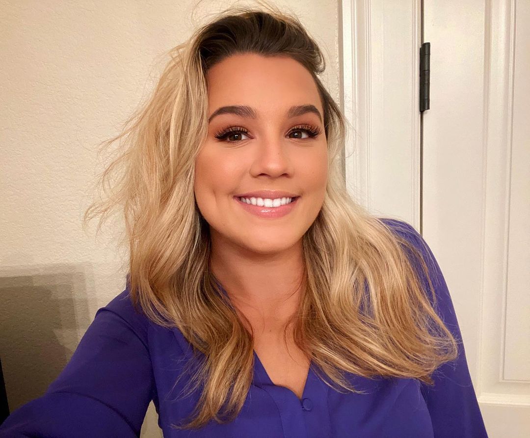 Gabby Barrett looks amzing in this beautiful purple shirt and a wholesome smile on her face.