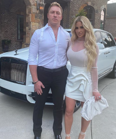 Kim Zolciak and husband Kroy Biermann pose with their Rolls Royce.