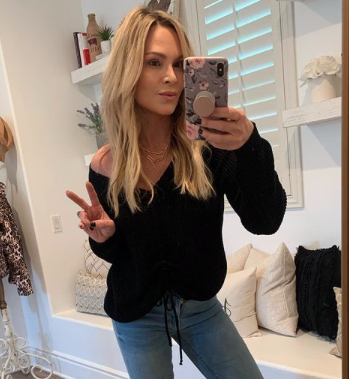 Tamra Judge wears a black sweater and jeans.