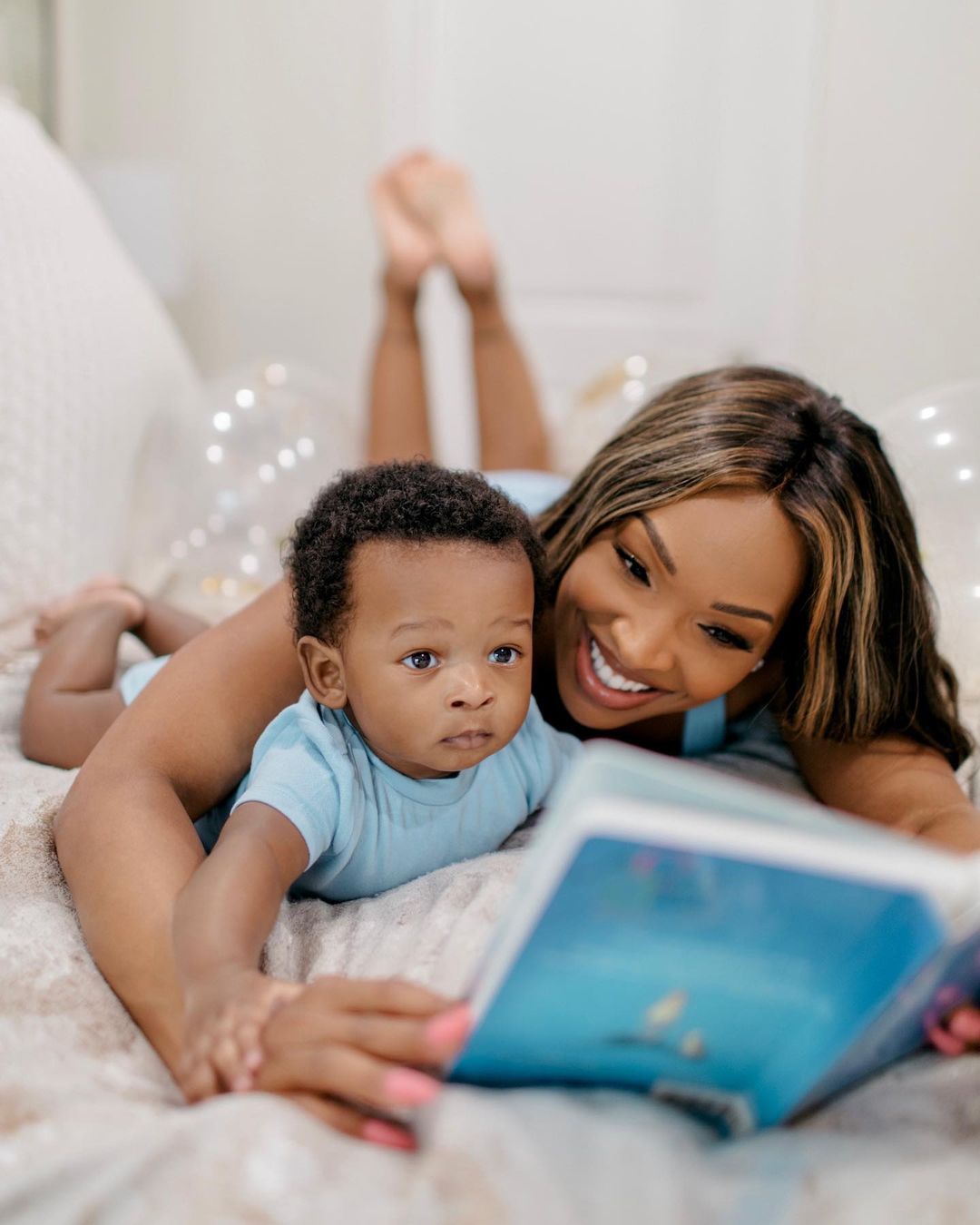 An awesome photo of Malika Haqq reading to her son.