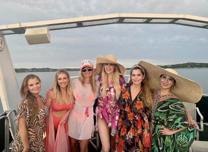 The 'RHOD' cast wears swimwear on a boat.