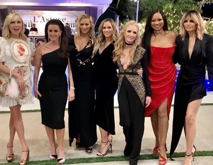 Garcelle Beauvais wears a red dress with 'RHOBH' cast.