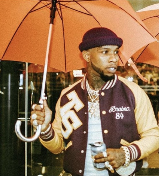 Lanez showing off an umbrella as a symbol of his record label.