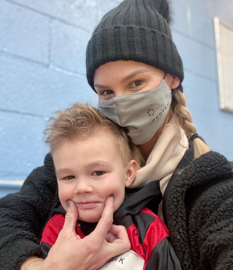 Meghan King Edmonds wears a mask with son Hayes.