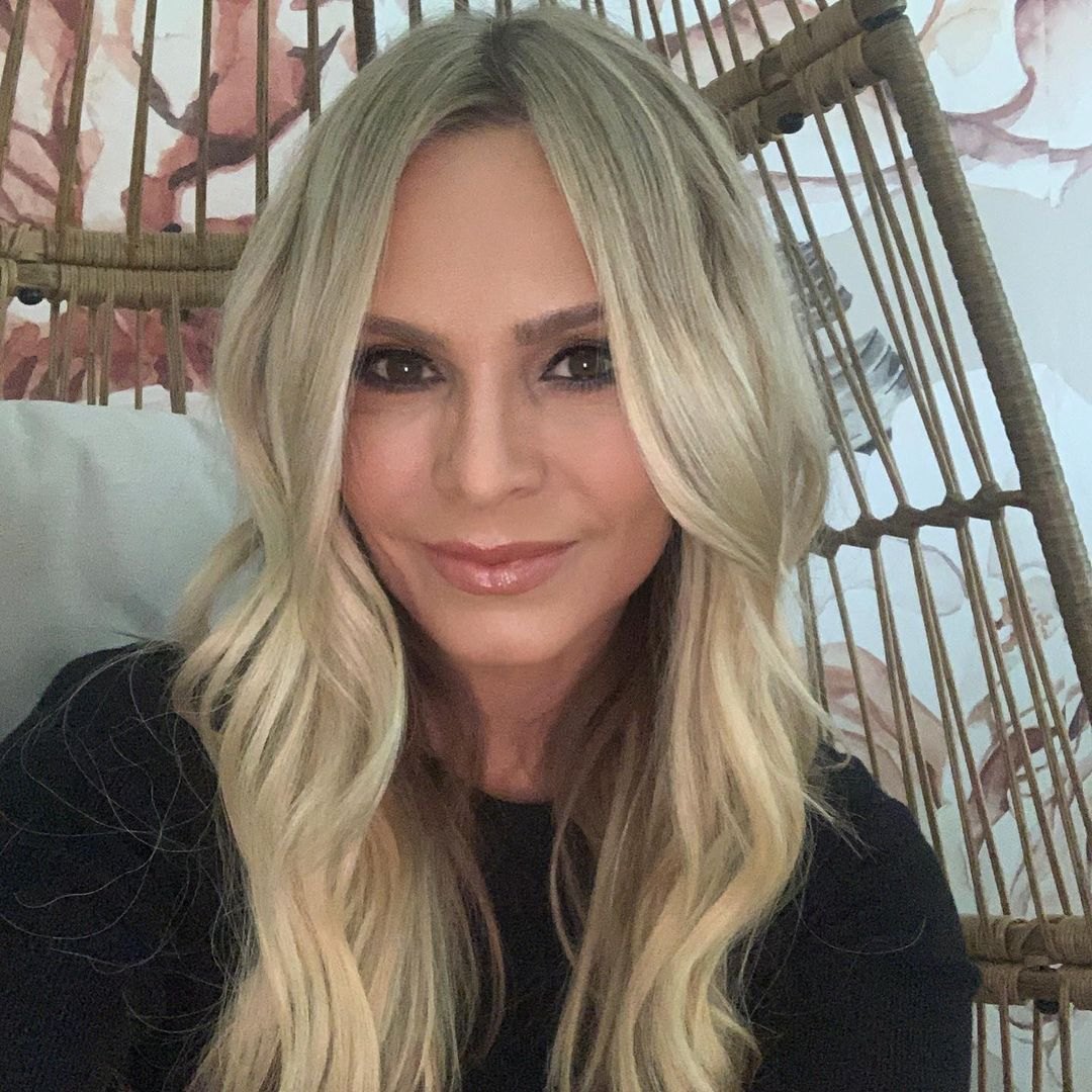 Tamra Judge wears a black shirt in a wicker chair.