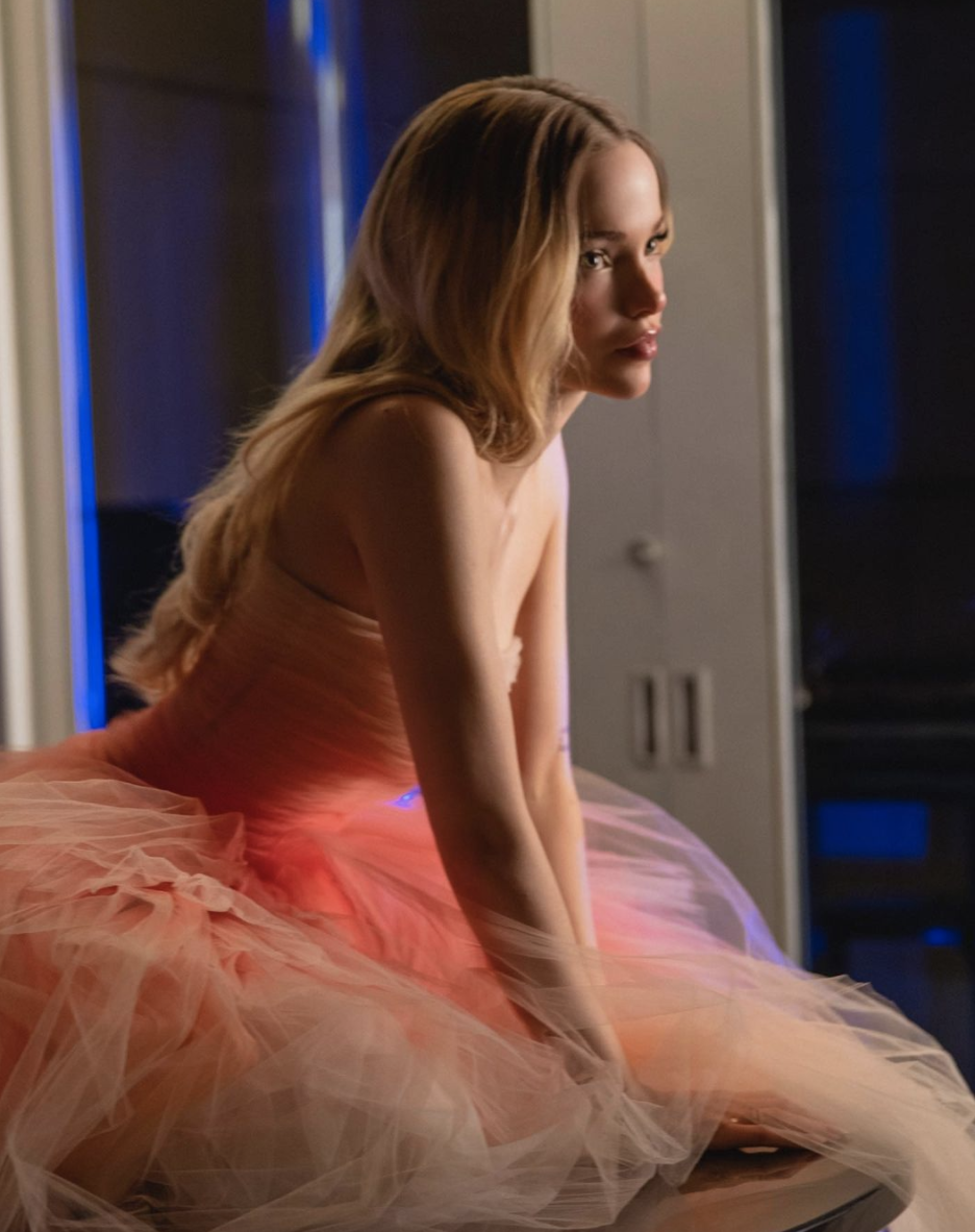 Dove Cameron in a pink gown on the video shoot of her 'We Belong' music video.