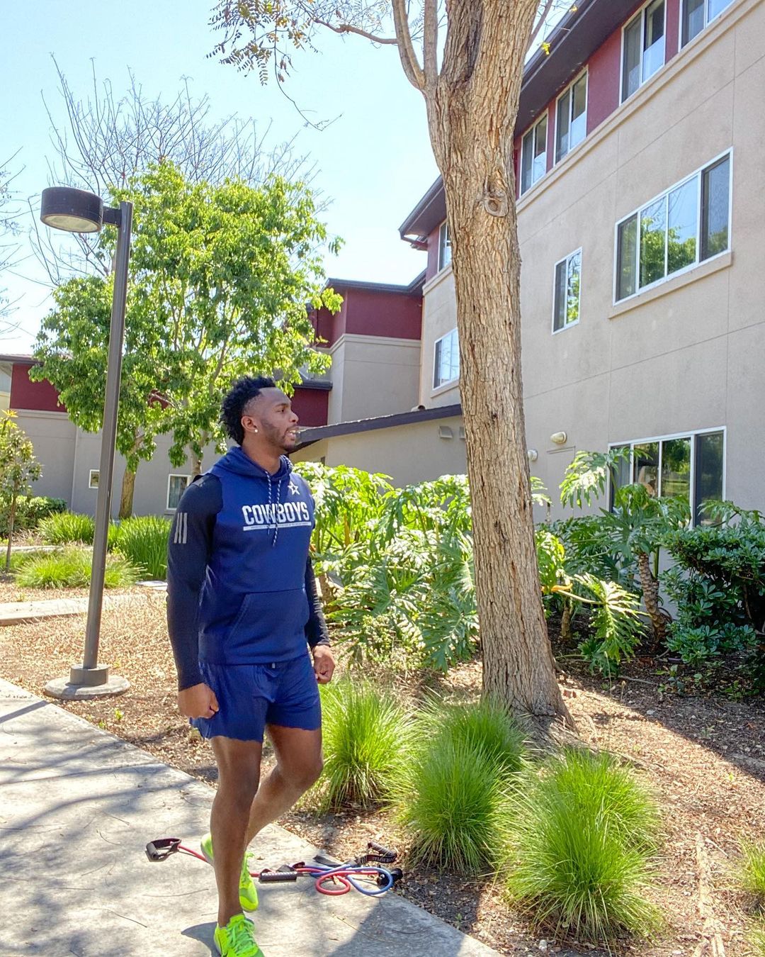 A photo of Uzoma Nwachukwu ready to get his workout on in a blue short and hoodie.