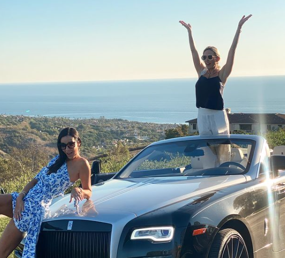 Braunwyn Windham-Burke and Noella Bergener pose on her Rolls Royce.