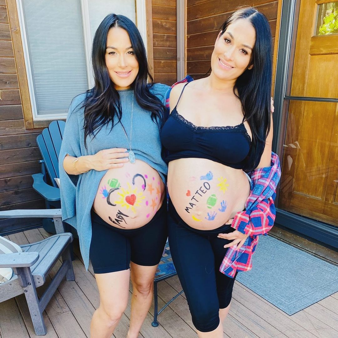 A throwback photo showing Brie and Nikki Bella eith the cutest baby bump, sporting indoor outfits and they look gorgeous.