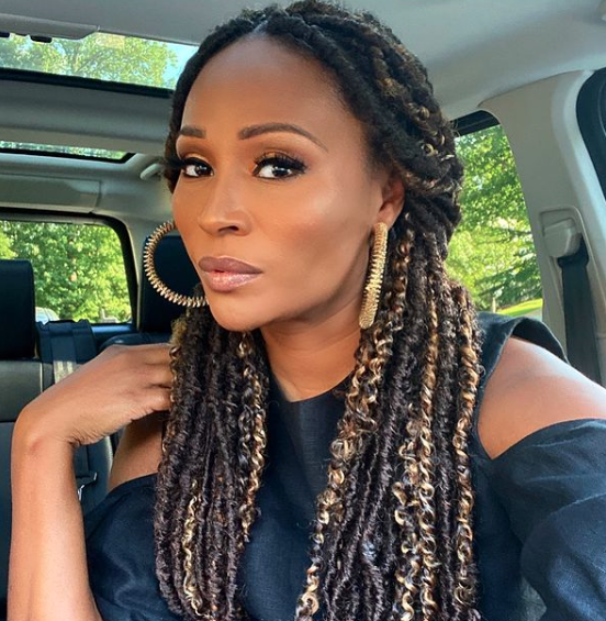 Cynthia Bailey wears braids in a car.