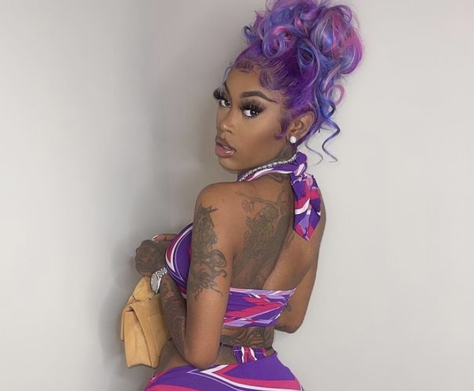 Doll showing off her dress and tattoos.