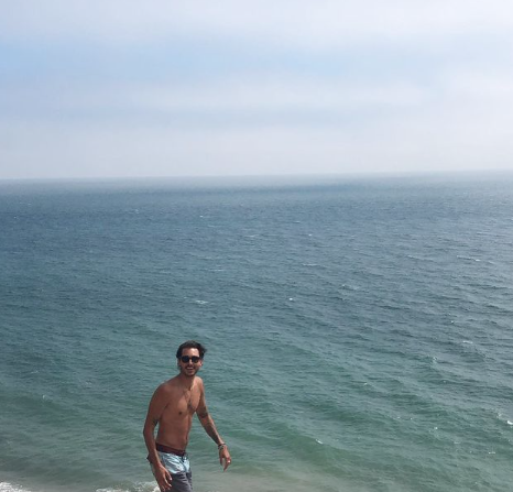 Max Boyens poses alongside the Pacific Ocean.