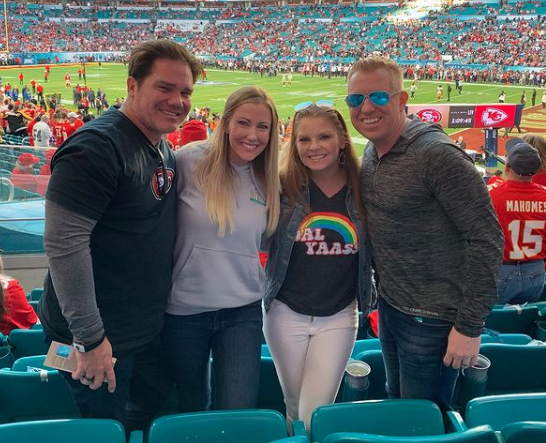 Stephanie Hollman and Brandi Redmond attend a football game with their husbands.