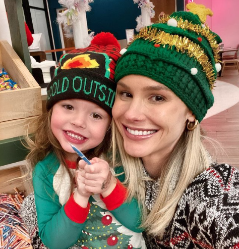 Meghan King Edmonds and daughter Aspen wear Christmas hats.