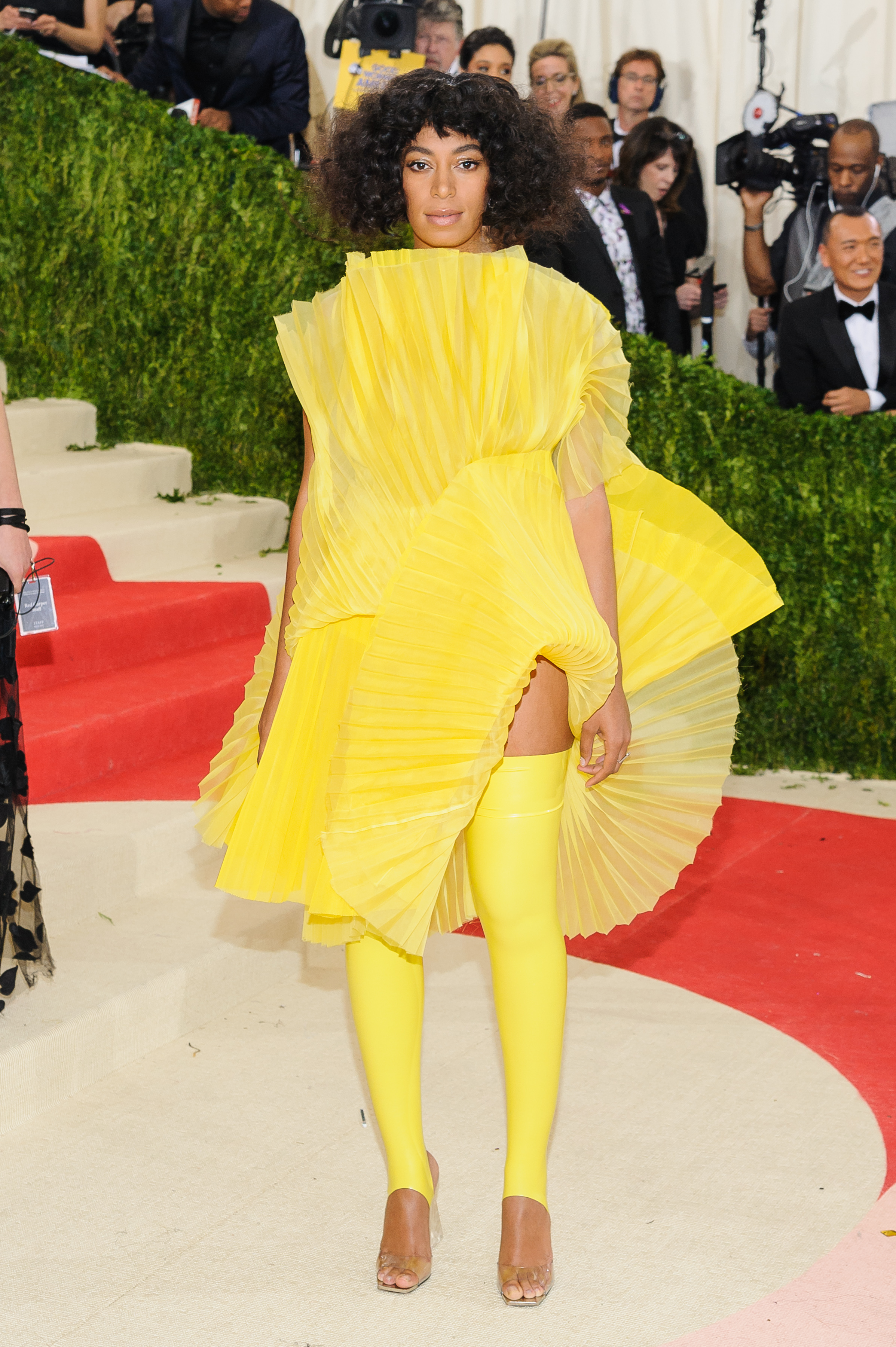 A photo of Solange Knowles in a two-piece yellow outfit at an awards event.