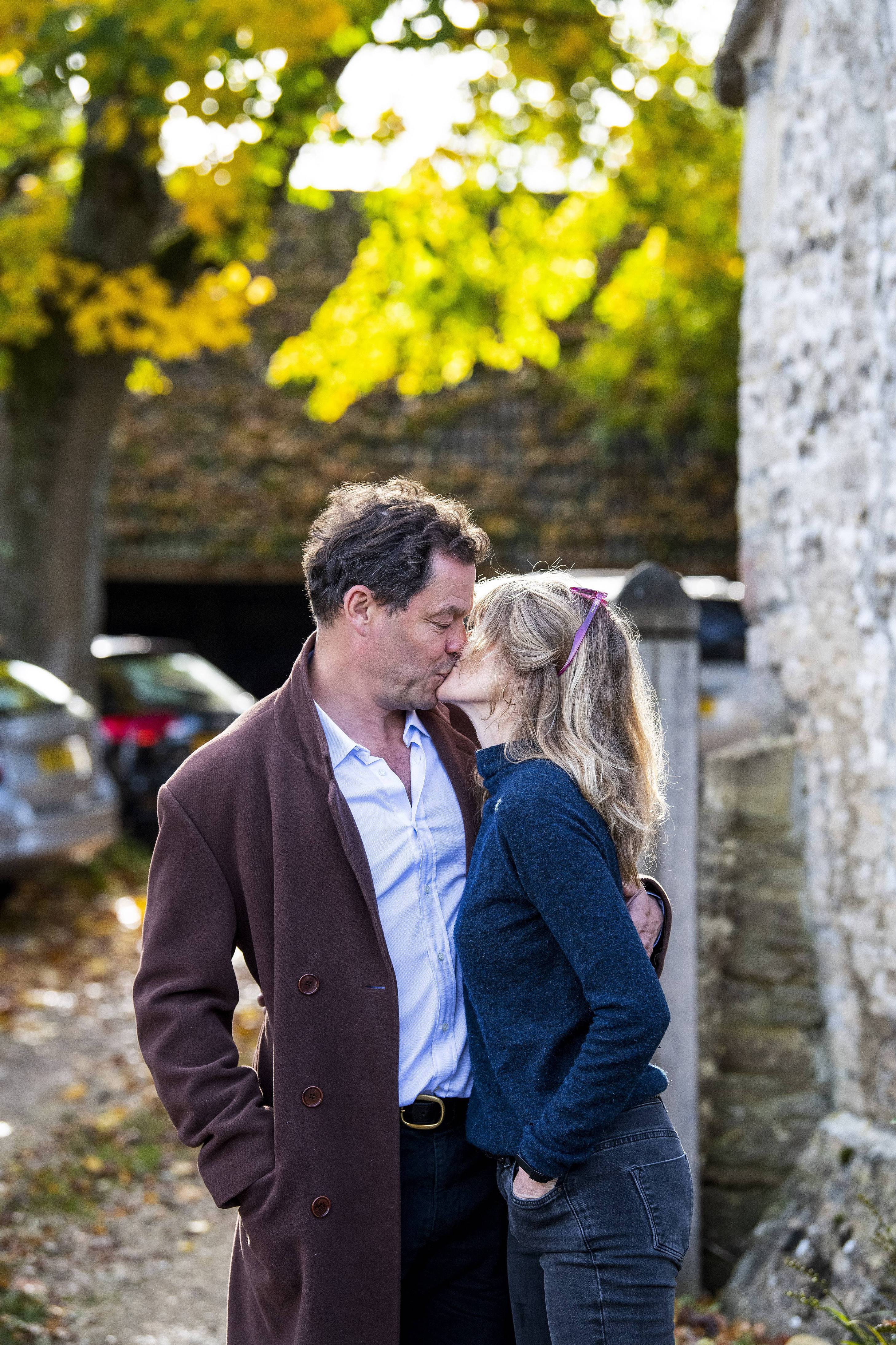 A photo of Catherine FitzGerald and Dominic West, engaged in a passionate kiss for the camera and they look adorable.