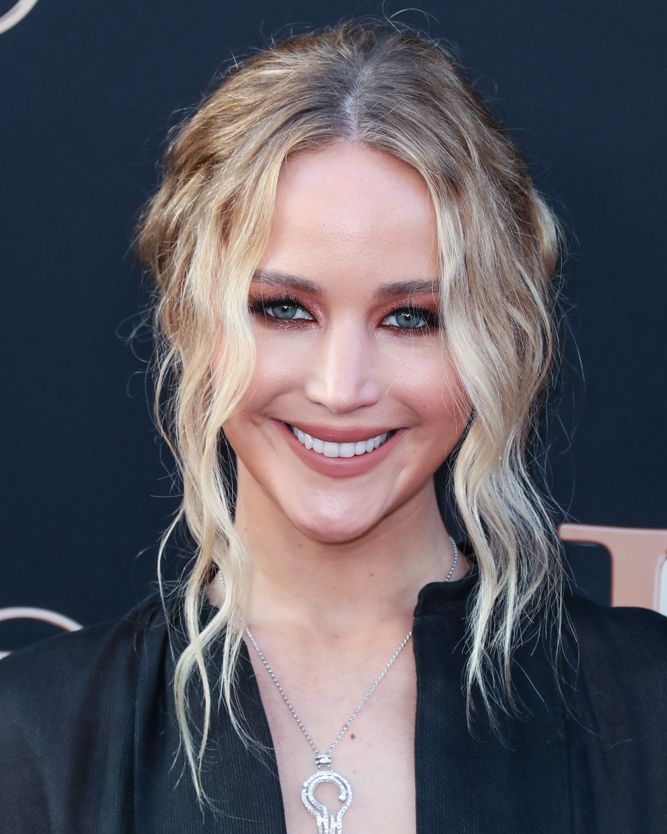 An awesome photo of Jennifer Lawrence smiling beautifully in a black outfit. 