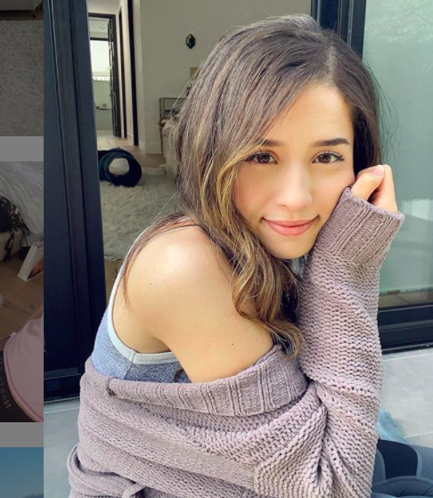 Pokimane posing with off the shoulder sweater.