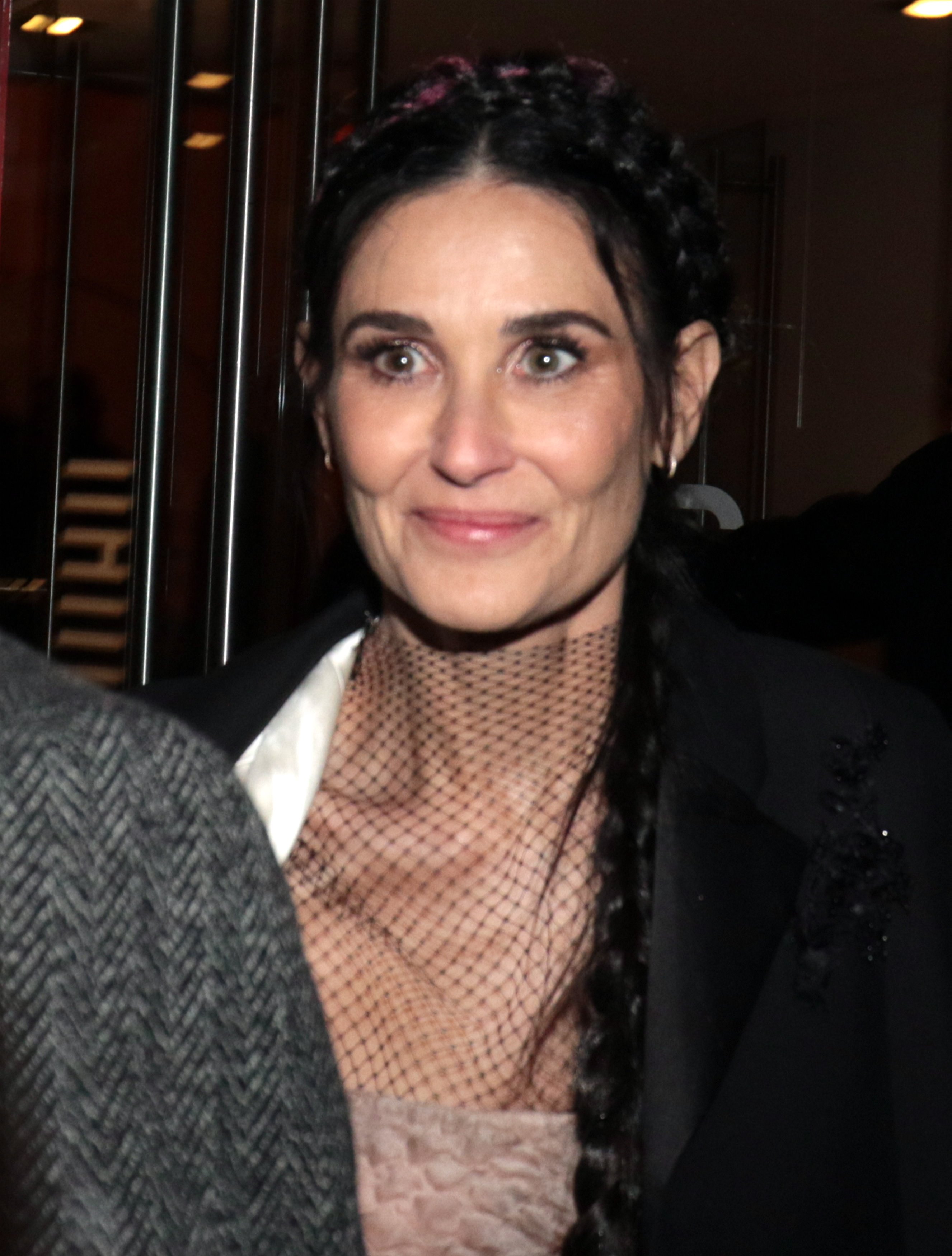 A beautiful looking Demi Moore smiling through her eyes at the Harper's Bazaar Paris Fashion week.