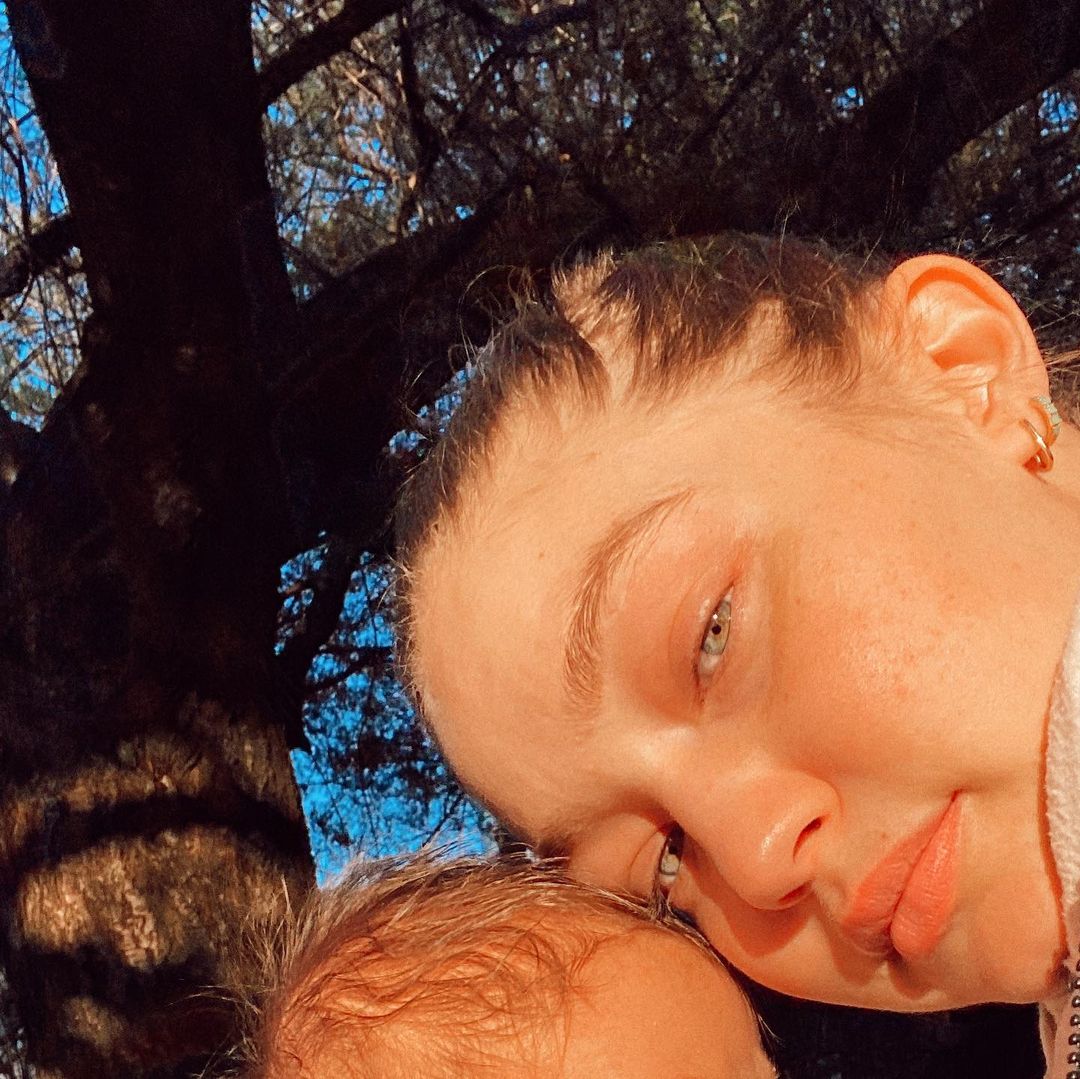 A picture of Gigi Hadid with her little daughter, whose face is cut out of the photo frame.