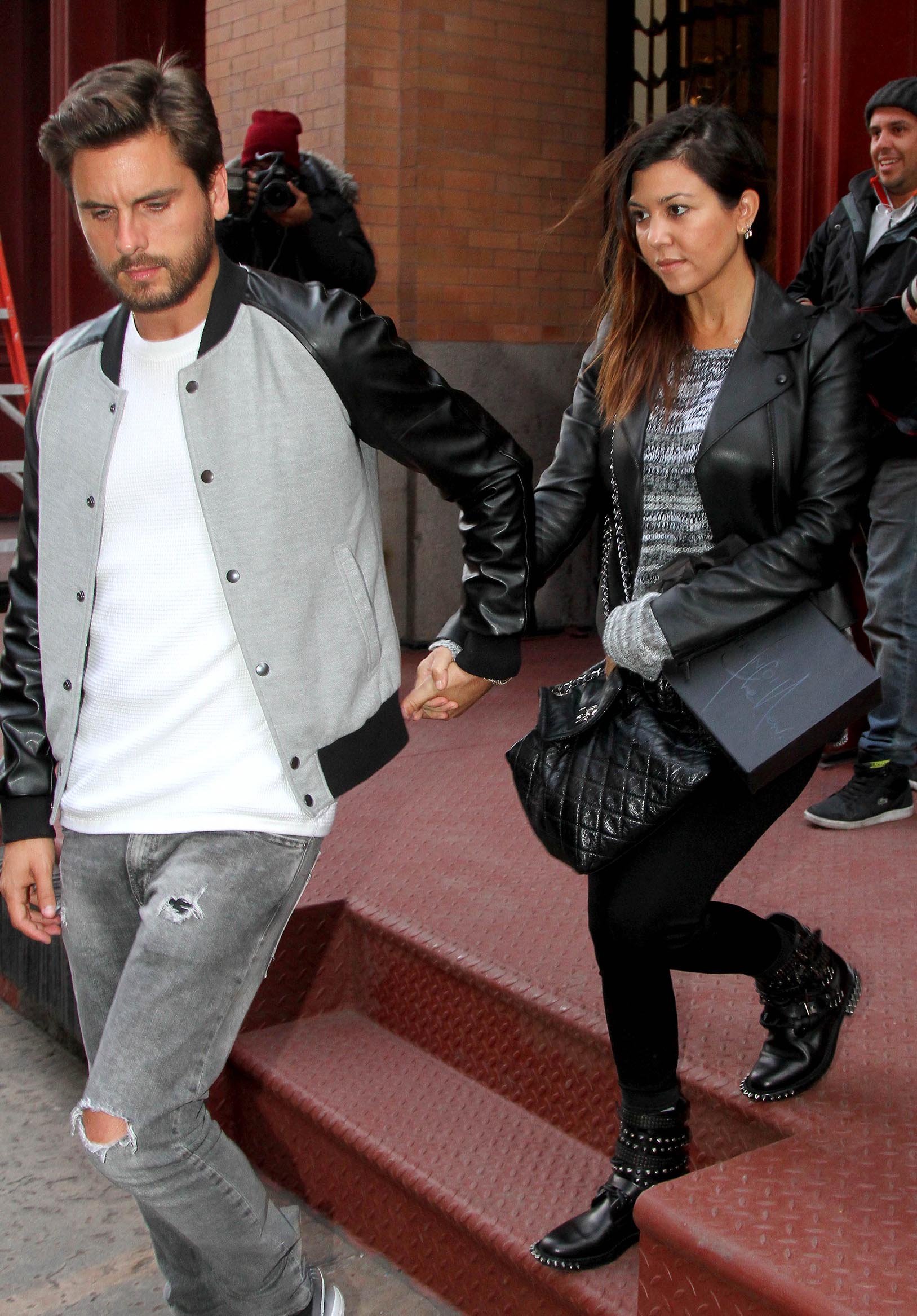 A throwback photo showing Kourtney Kardashian and Scott Disick exiting a building together.