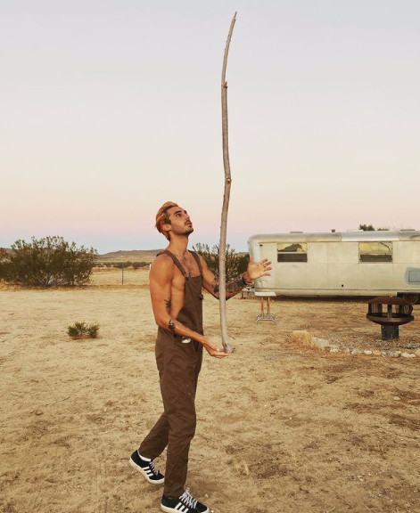 Max Boyens is seen balancing a large stick.