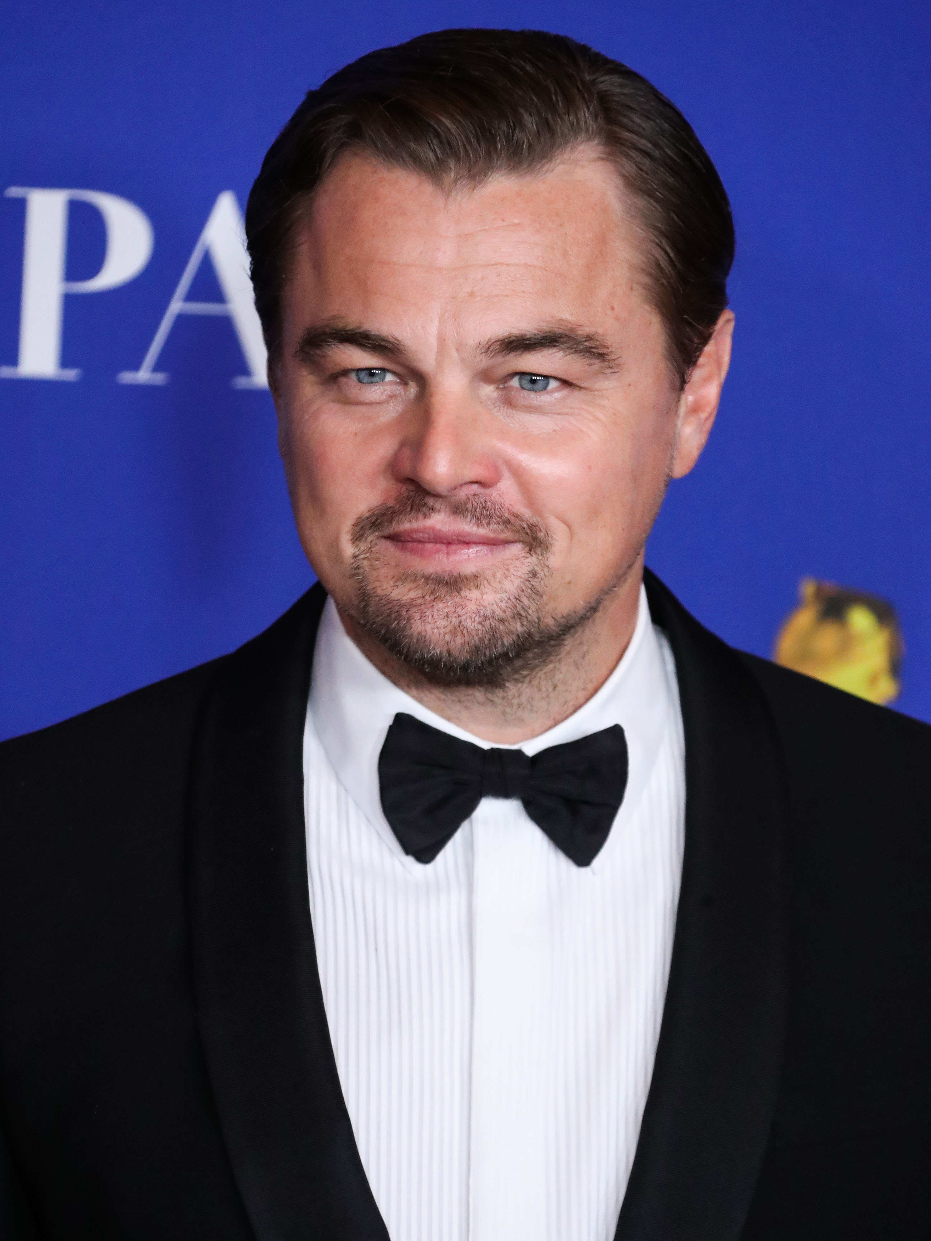 Leonardo DiCaprio is proof that people can age backwards in this photo showing him in a black tux, paired with a black bow tie and plain white inner T-shirt.