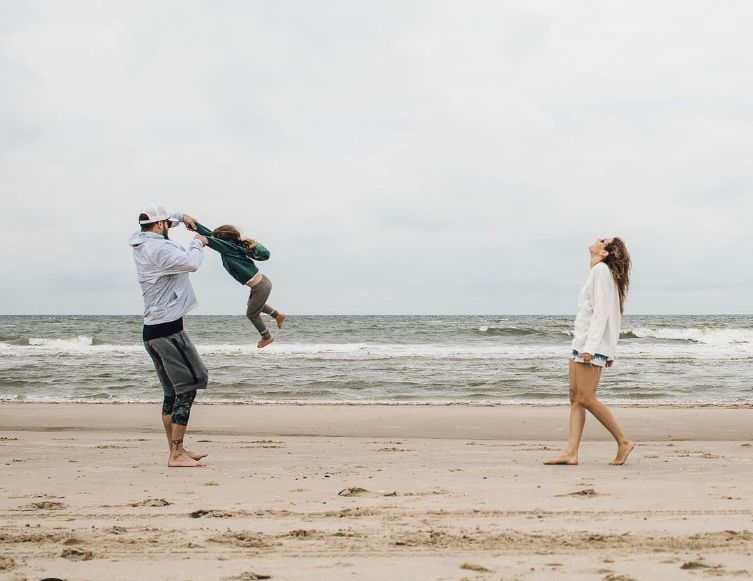 Justin Timberlake and Jessica Biel on beach with child