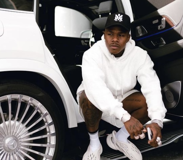 DaBaby in front of his Mercedes-Benz.