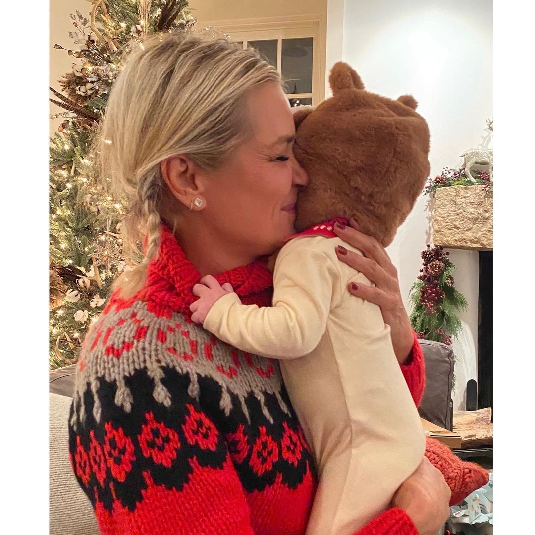 A photo showing Yolanda Hadid holding her granddaughter, who's dressed in a cute white onsie.