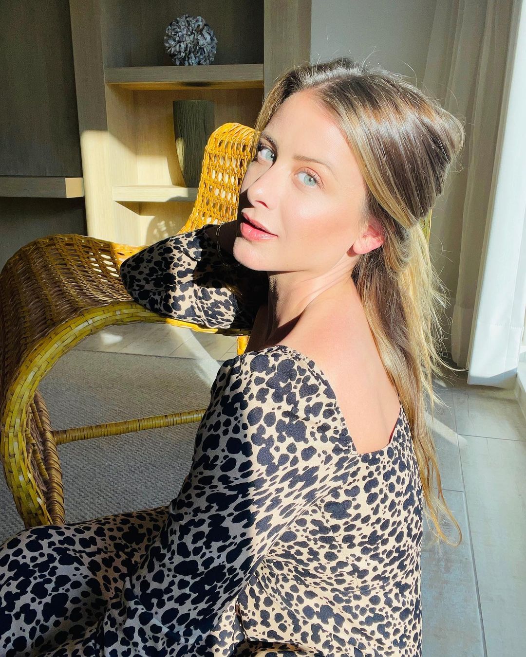 A photo of Lauren Bosworth styled in a spotted design dress in the comfort of her home. 