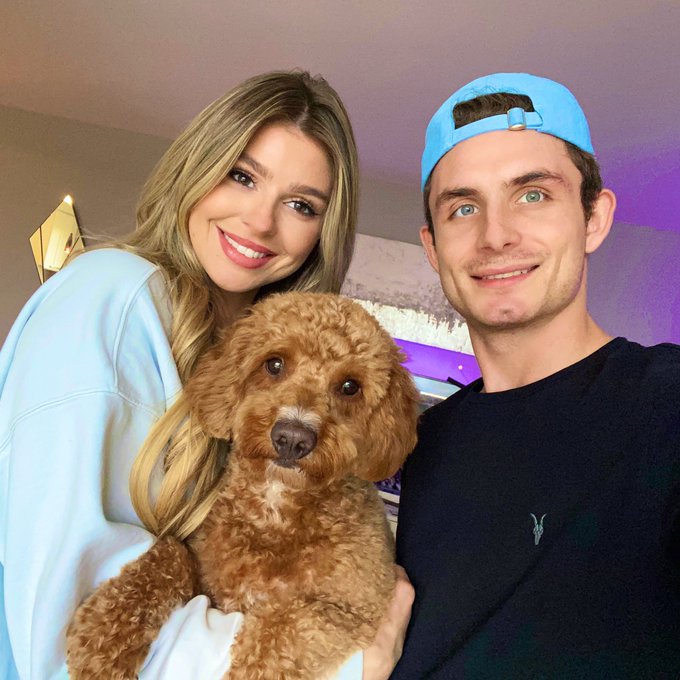 James Kennedy and Raquel Leviss hold their dog.