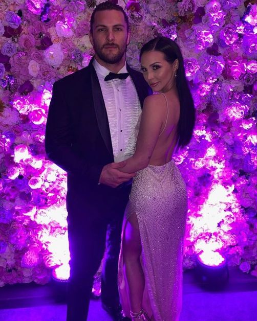 Brock Davies wears a suit and Scheana Shay wears a white gown.