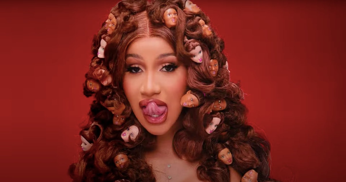 Cardi licking her lips in the 'Up' video.