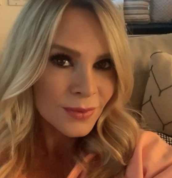 Tamra Judge takes a selfie in a pink shirt.