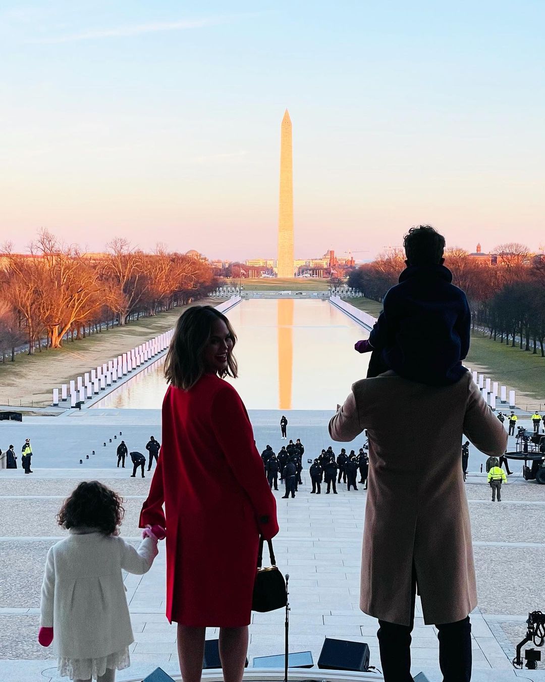 A photo of Chrissy Teigen with her husband and children on an outing.