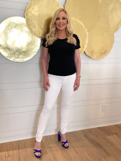 Shannon Beador wears white pants and a black T-shirt.