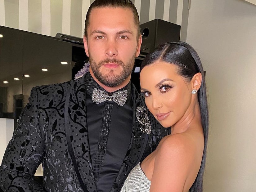 Scheana Shay wears a sliver dress with boyfriend Brock Davies.