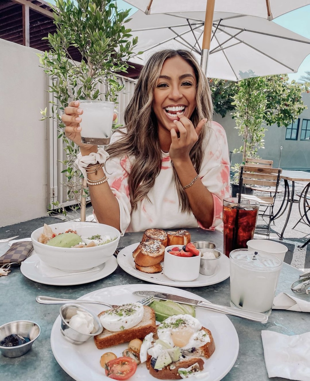 Tayshia Adams poses for a photo during a meal