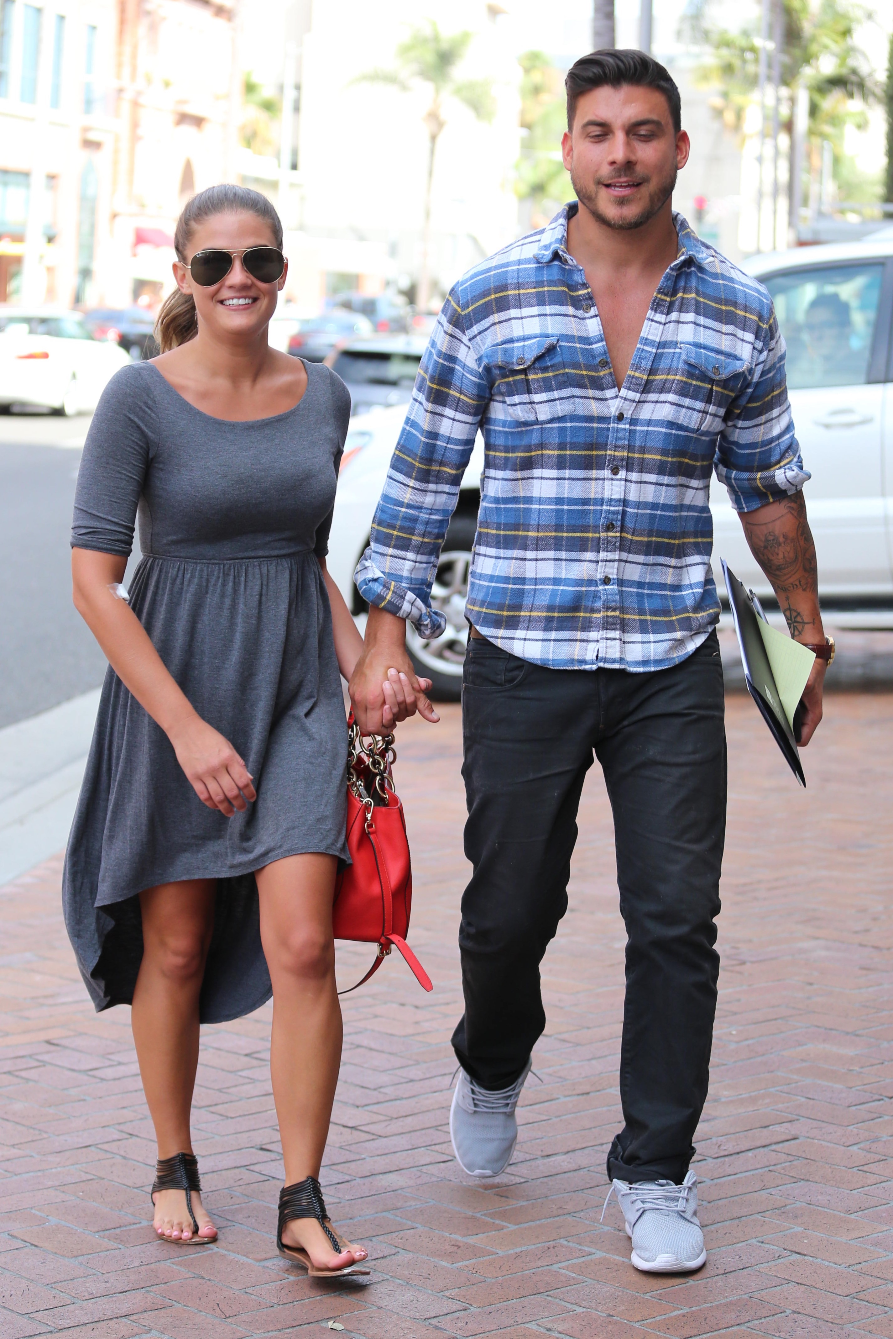 A throwback photo showing Jax Taylor and girlfriend, Carmen Dickman, taking a casual stroll on a sunny day.