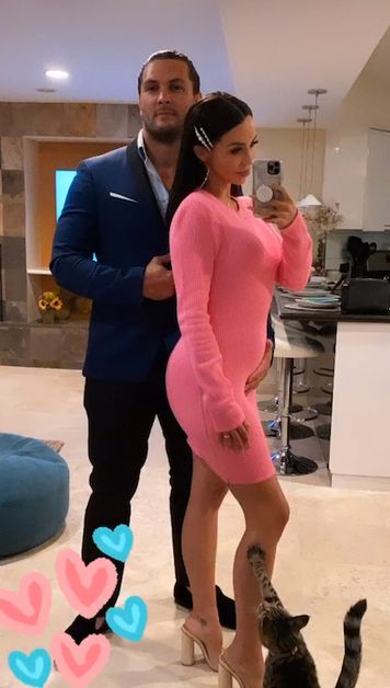 Scheana Shay shows off baby bump in pink dress.