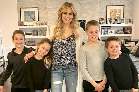 Jackie Goldschneider wears a leopard print cami with her two sets of twins.