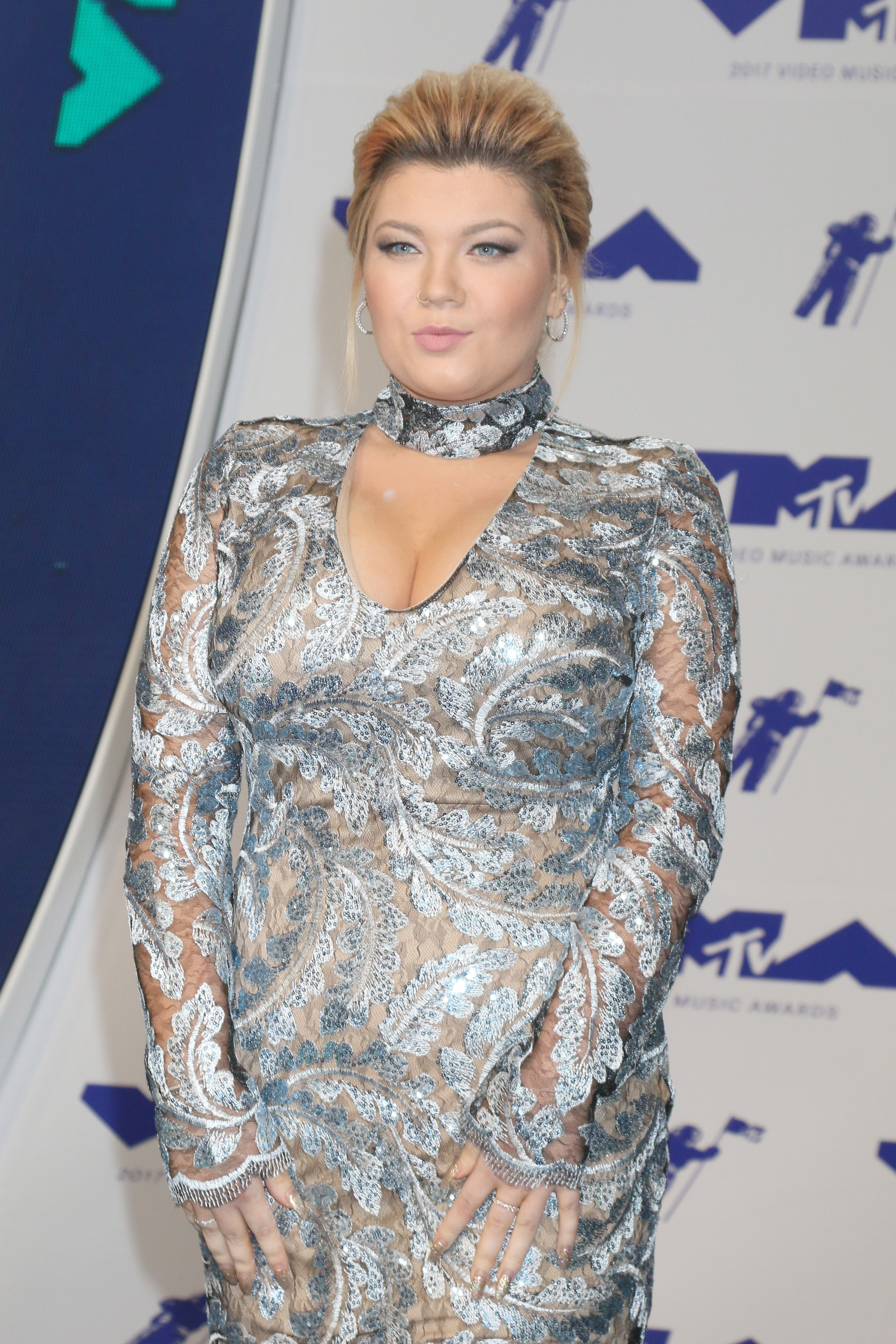 A lovely photo showing Amber Portwood at an event, in this see-through outfit, and she looks incredible.